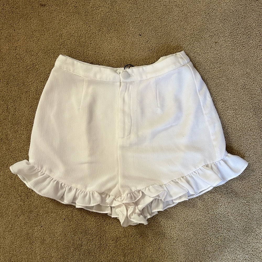 Woman’s size small white shorts with ruffles.